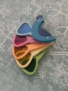 This peacock has 5 tail feathers with colored acrylic windows and they can be opened and closed like a real peacock. A great toy for children to learn about colors and color mixing. 
